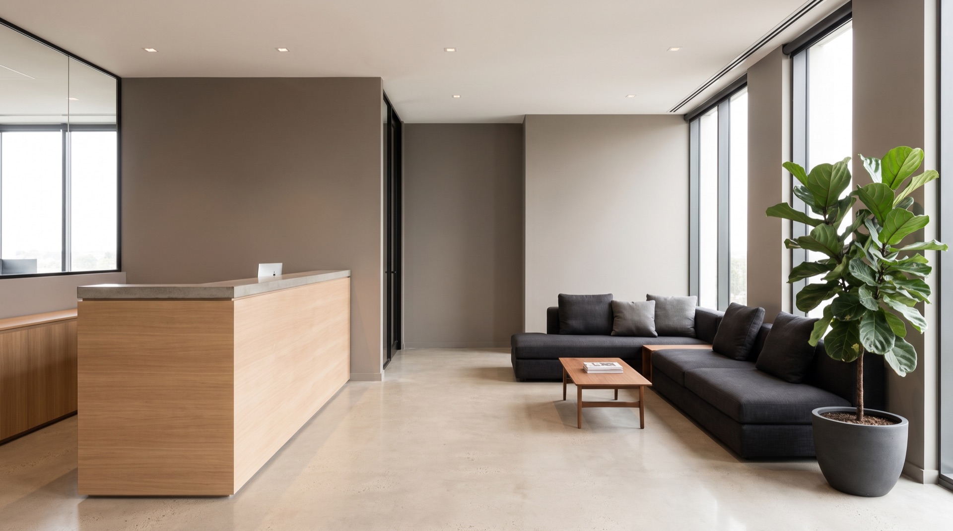 Office reception and waiting area with a reception counter and sofa seating